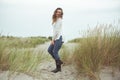 Portrait of pretty young woman posing on the Baltic sea beach in autumn Royalty Free Stock Photo