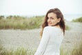 Portrait of pretty young woman posing on the Baltic sea beach in autumn Royalty Free Stock Photo