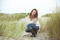 Portrait of pretty young woman posing on the Baltic sea beach in autumn Royalty Free Stock Photo