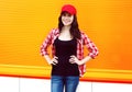 Portrait of pretty young woman in red cap and checkered shirt Royalty Free Stock Photo