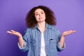 Portrait of pretty young woman shrug shoulders wear denim shirt isolated on purple color background