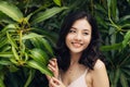 Portrait of pretty young woman standing near leaves outdoors Royalty Free Stock Photo