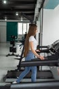 Portrait of pretty young woman taking a break from running on treadmill machine at gym Royalty Free Stock Photo