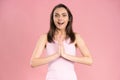 Portrait of pretty young woman wearing pink t-shirt begging or praying with hands together, hope and joy expression on her face Royalty Free Stock Photo