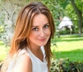 Portrait of prety smiling young woman outdoors