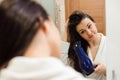 Portrait of prety young woman using hairdryer. Royalty Free Stock Photo