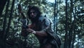 Portrait of Primeval Caveman Wearing Animal Skin and Fur Hunting with a Stone Tipped Spear in the