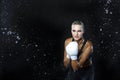 Portrait of Professional Active Female Boxer Posing with White Gloves in Aqua Studio Against Black Background