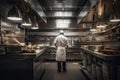 Portrait of a professional chef standing in the kitchen of a restaurant, A chefs full rear view inside a modern kitchen, preparing Royalty Free Stock Photo