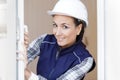 Portrait professional female builder at open window Royalty Free Stock Photo