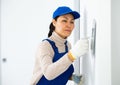 Portrait of professional female builder in process of repair at house