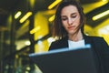 Portrait professional female finance lawyer standing near office in evening street communicates online by tablet. Businesswoman Royalty Free Stock Photo