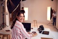 Portrait Of Professional Female Photographer Working In Studio With Assistants Royalty Free Stock Photo