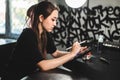 Portrait of a professional female tattooist in a tattoo studio draws a sketch on a tablet Royalty Free Stock Photo