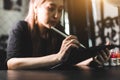 Portrait of professional female tattooist in tattoo studio