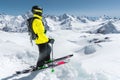 Portrait of a professional freerider skier standing on a snowy slope against the background of snow-capped mountains Royalty Free Stock Photo