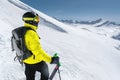 Portrait of a professional freerider skier standing on a snowy slope against the background of snow-capped mountains Royalty Free Stock Photo