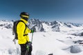 Portrait of a professional freerider skier standing on a snowy slope against the background of snow-capped mountains Royalty Free Stock Photo