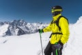 Portrait of a professional freerider skier standing on a snowy slope against the background of snow-capped mountains Royalty Free Stock Photo