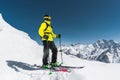 Portrait of a professional freerider skier standing on a snowy slope against the background of snow-capped mountains Royalty Free Stock Photo