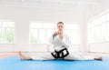 Portrait of karate girl black belt degree, stretching her legs before hard training. Royalty Free Stock Photo