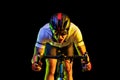 Portrait of professional male cyclist in sports uniform, goggles and helmet on dark background in yellow neon light Royalty Free Stock Photo