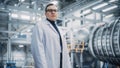 Portrait of a Professional Male Heavy Industry Engineer/Worker Wearing White Laboratory Coat and