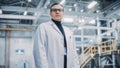 Portrait of a Professional Male Heavy Industry Engineer/Worker Wearing White Laboratory Coat and
