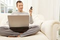 Portrait of professional man with laptop and smart phone at home. Royalty Free Stock Photo