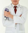 Portrait of a professional medical male doctor standing on white background with crossed arms, wearing white gown coat, and Royalty Free Stock Photo