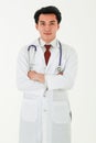 Portrait of a professional medical male doctor standing on white background with crossed arms, wearing white gown coat, and Royalty Free Stock Photo