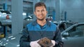 Portrait of Professional smiling car mechanic working in modern auto repair service Royalty Free Stock Photo