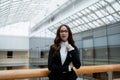 Portrait of a professional woman in a suit standing in a modern office. Royalty Free Stock Photo