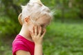 Portrait in profile of pretty blond toddler girl in a windy summer day Royalty Free Stock Photo