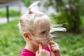 Portrait in profile of pretty blond toddler girl in a windy summer day Royalty Free Stock Photo