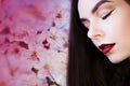 Portrait in profile, young beautiful brunette woman with bright lips. Lipstick purple color, Royalty Free Stock Photo