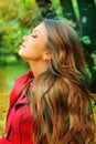 Portrait in profile of a young beautiful girl resting in a park.