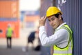 Portrait of proud engineer in protective workwear standing in a shipping yard