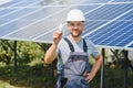 The portrait of a proud engineer smiles satisfied with his successful work. Concept: renewable energy, technology