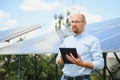 The portrait of a proud engineer smiles satisfied with his successful work. Concept: renewable energy, technology