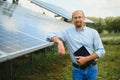 The portrait of a proud engineer smiles satisfied with his successful work. Concept: renewable energy, technology