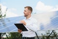 The portrait of a proud engineer smiles satisfied with his successful work. Concept: renewable energy, technology