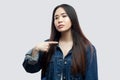 Portrait of proud satisfied beautiful brunette asian young woman in casual blue denim jacket with makeup standing pointing herself Royalty Free Stock Photo