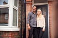 Portrait Of Proud Young Couple Standing Outside First Home Together Royalty Free Stock Photo