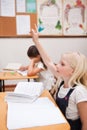 Portrait of a pupil raising her hand Royalty Free Stock Photo