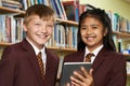Portrait Of Pupils Wearing School Uniform Using Digital Tablet I Royalty Free Stock Photo