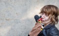 Portrait of a puppeteer with strange facial expression playing with a Kasper doll with hat and red nose Royalty Free Stock Photo