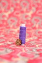 Portrait of purple sewing thread and button Royalty Free Stock Photo