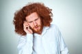 Portrait of puzzled man talking on the phone a gray background Royalty Free Stock Photo