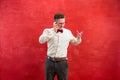 Portrait of puzzled man talking by phone a red background Royalty Free Stock Photo